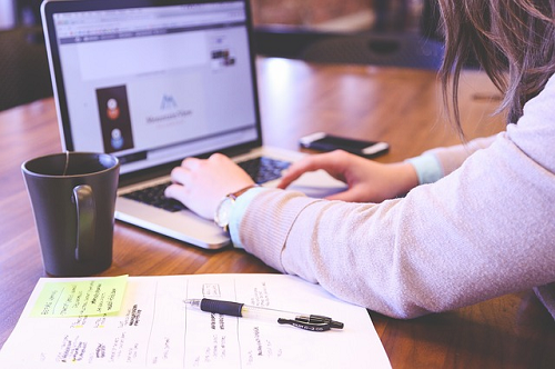 managing brand reputation online, woman working at computer